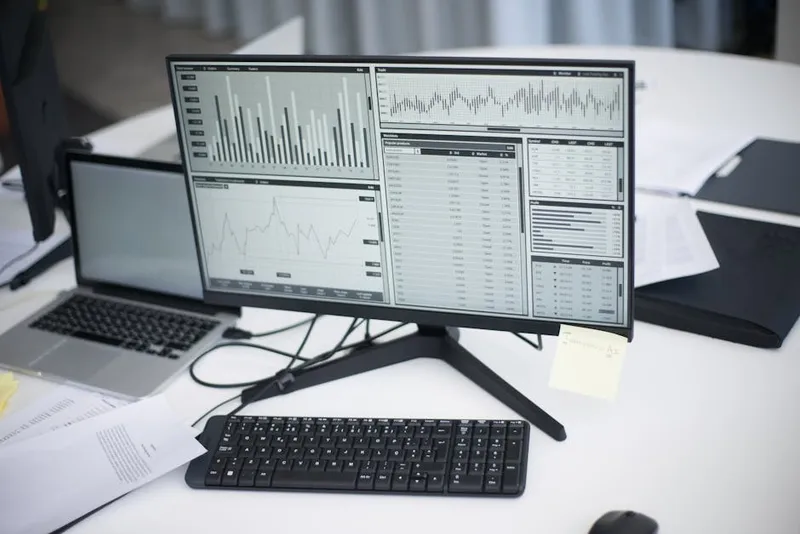 computer monitor charts data analytics dark room