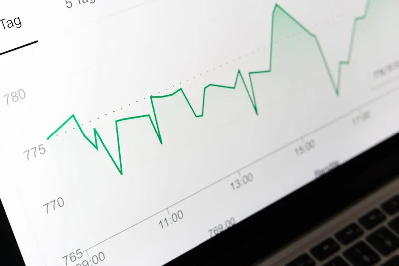 upward financial line chart laptop screen