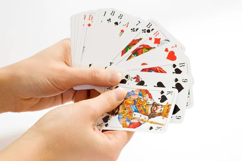 three playing cards fanned close hand