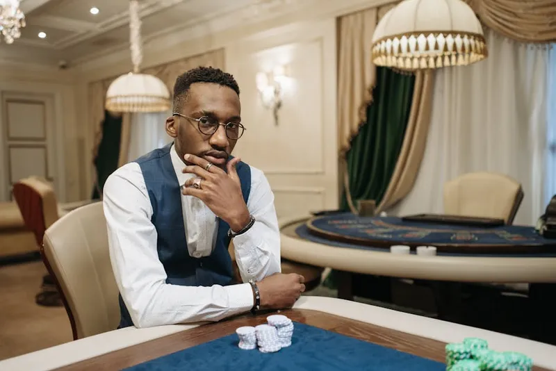 lone blackjack player chip stack contemplating
