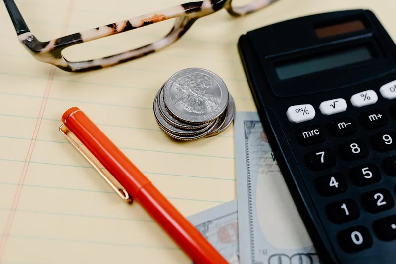 calculator coins money planning desk