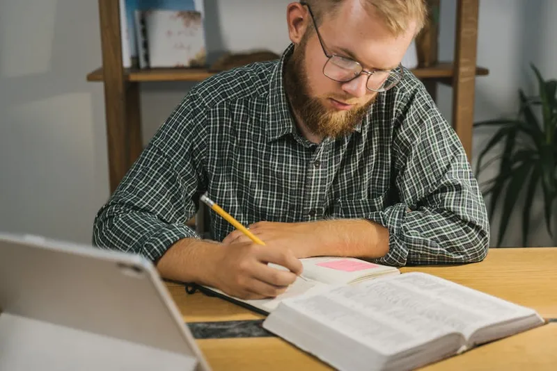 man focused studying notebook