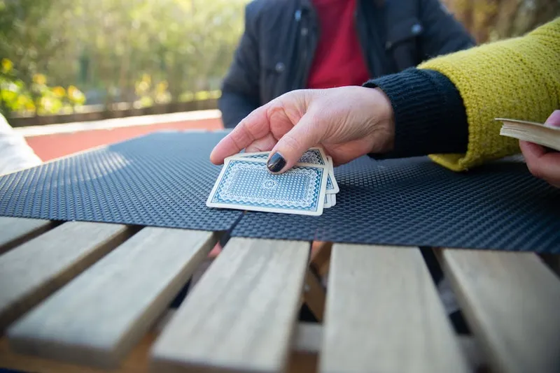 hands shuffling deck of cards