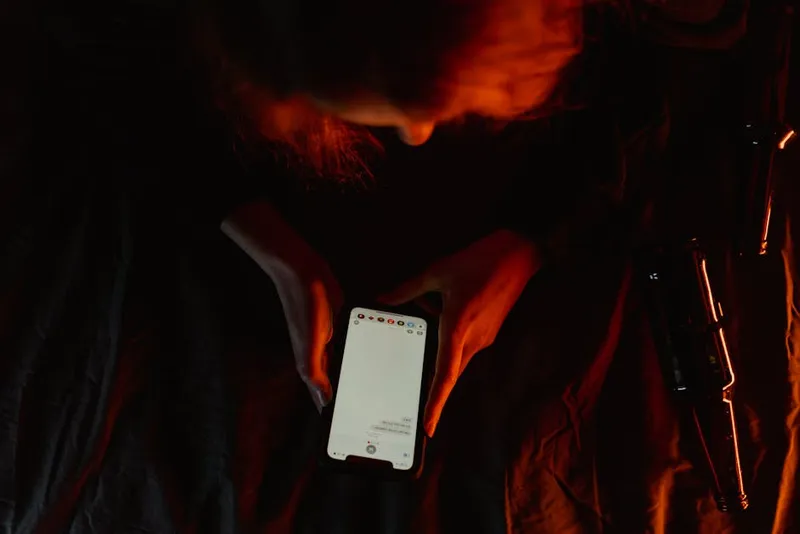 person using smartphone in dark