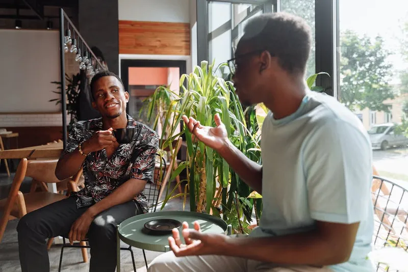 two men talking in coffee shop
