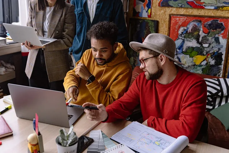two people reviewing laptop together