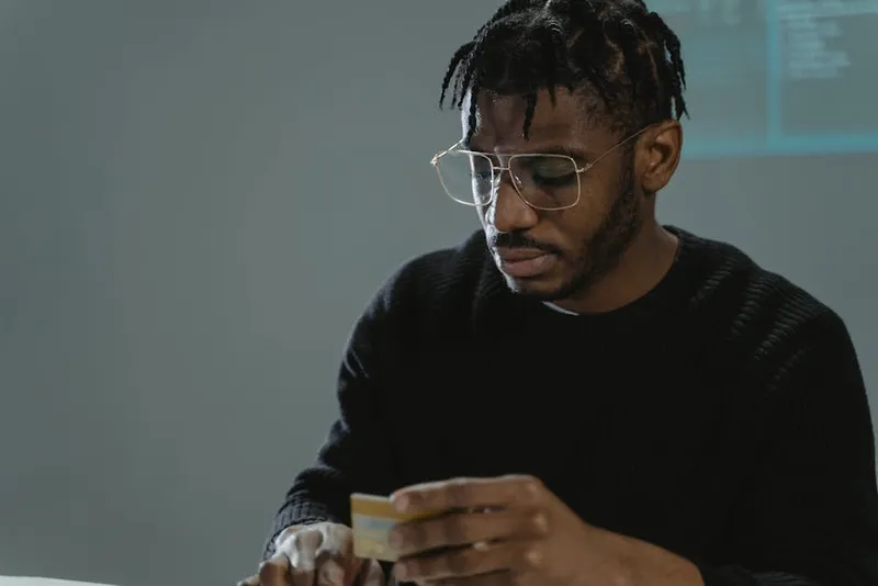 man focused studying cards