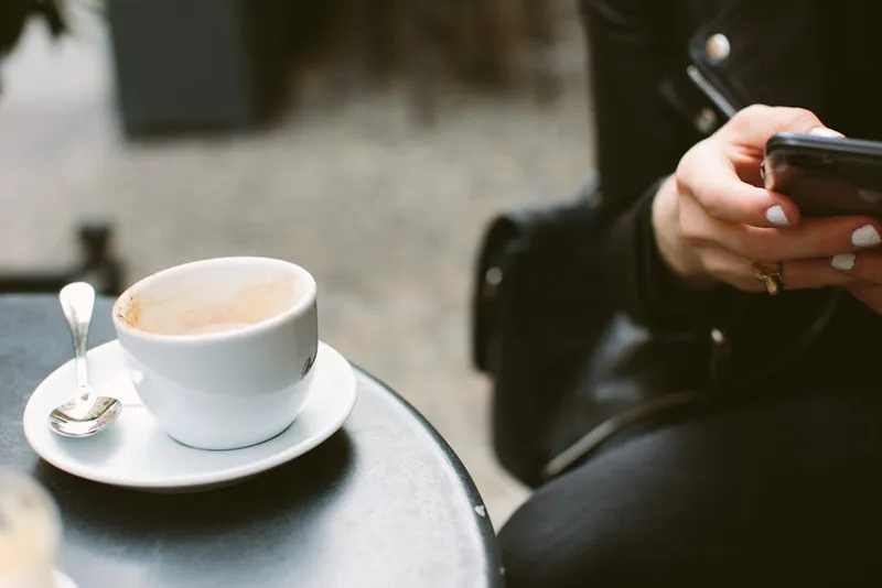 smartphone hand cafe person