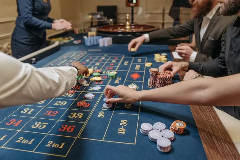 gambler hand pushing casino chip bet
